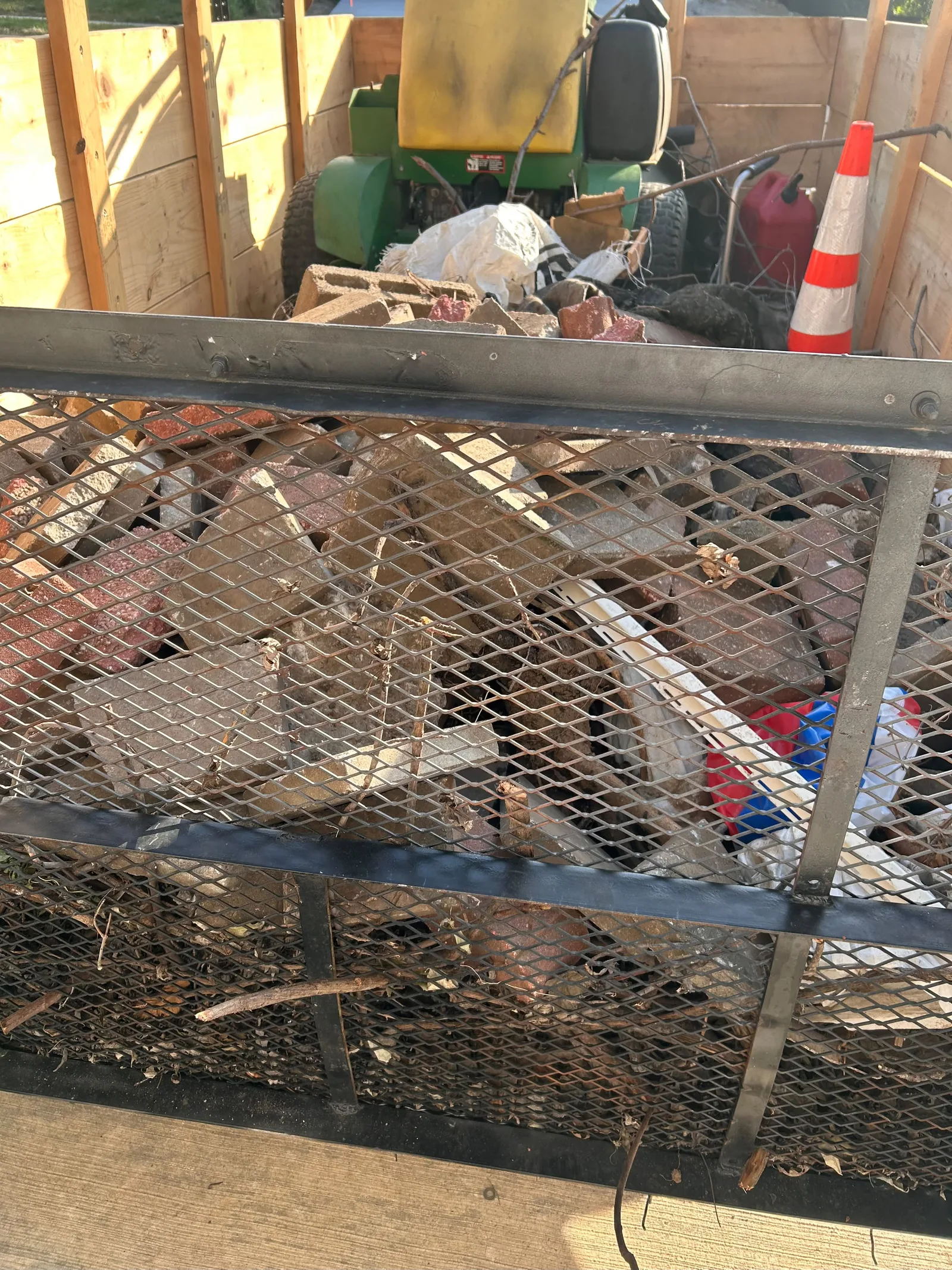 Utility trailer filled with broken masonry and yard debris for hauling